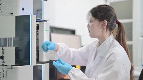 Scientist in laboratory conducting research with advanced equipment and computer analysis