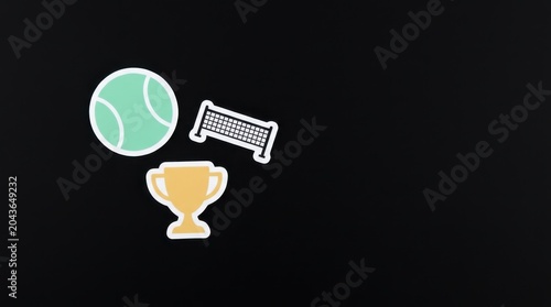 Sports Achievement Concept. Tennis ball, victory trophy, and net icons, flat paper cutouts on black background, athletic competition and tournament planning
