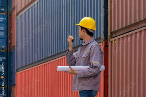 Cuadro en lienzo Asian male logistics coordinator or industrial engineer wearing yellow safety ha