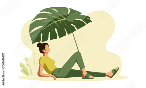   girl is resting under a large palm leaf