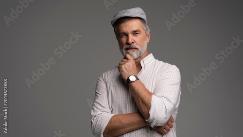Bilde på lerret Smiling man wearing white shirt and flat cap, close-up