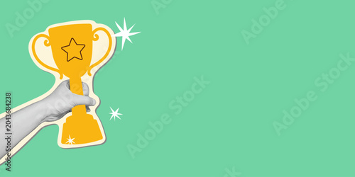 Foto Human hand holding a champion trophy in retro collage style on green background