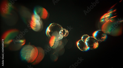 Floating Soap Bubbles with Chromatic Aberration and Colorful RGB Ghosting Lens Flare on Black Background