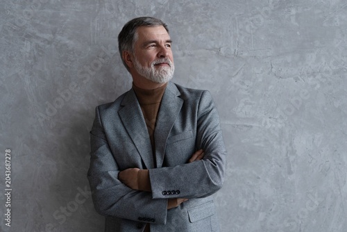 Entrepreneur in jacket smiling, Happy mid adult, mature age man standing, smiling, isolated on grey background