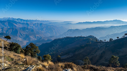 Panoramic view of the himalayan mountain range with terraced fields and morning mist in Nilgiri
