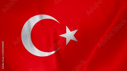 Close up of the Turkish flag waving with a crescent moon and star symbol in red and white fabric texture