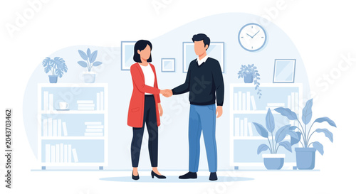 Two professionals, a man and a woman, shake hands in an office, symbolizing a successful business agreement and partnership, dressed in casual attire.