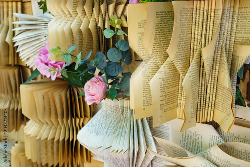 Creative use of old books in decoration with flowers and pages displayed