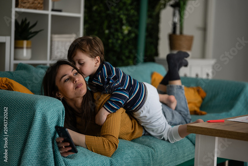 Bild auf Leinwand Mother and child bonding on sofa at home