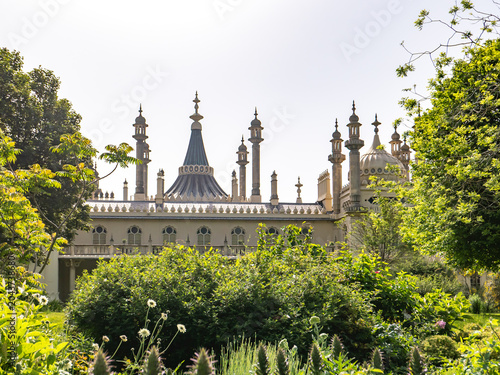 Public gardens. Lush foliage with historic building in the background