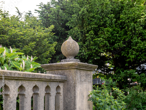Close and selective focus on a concrete post and ball in a public garden