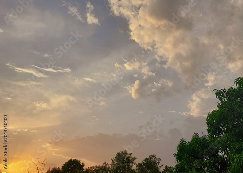 sunset in the cloudy sky, sunlight through clouds background, nature photography, natural wallpaper 