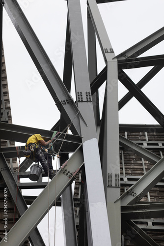 Painters performing rope access work. Workplace safety. Personal protective equipment. Hazardous profession