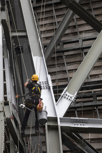 Painters performing rope access work. Workplace safety. Personal protective equipment. Hazardous profession