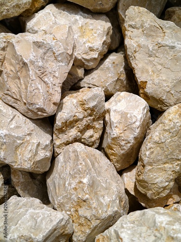 Close-up of beige crushed limestone rocks piled together