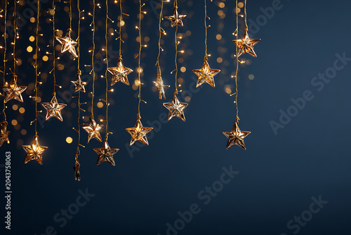 Elegant golden star ornaments hanging from twinkling lights create a festive, magical mood perfect for holiday celebrations and seasonal promotions