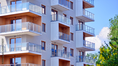 фотографія View of modern residential building with glass balconies and bright facade