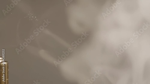 Perfume bottle with smoke, abstract background
