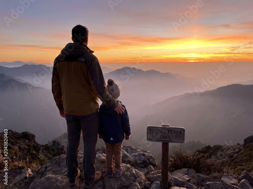 Rear View of Father and Child Standing on Mountain Overlook, Gearing Towards Breathtaking Sunrise, Symbolizing Guidance Protection and Future Aspirations, Epic Landscape Cinematic Composition