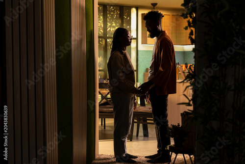 Fotografía African American couple, reconnecting, after argument, expressing affection, and comfort in a quiet home setting, Tenderness and empathy used in making peace, rebuilding trust to save relationship