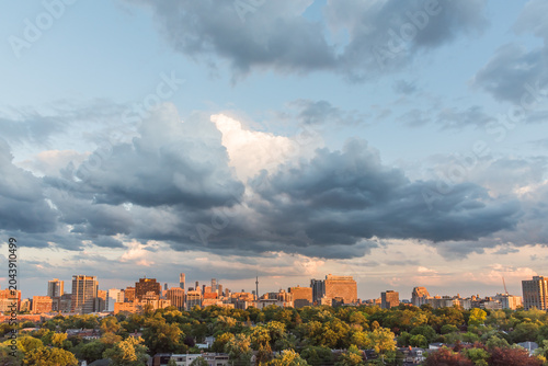 Photography Cloud-filled evening sky above the Toronto skyline with warm sunset light in Canada