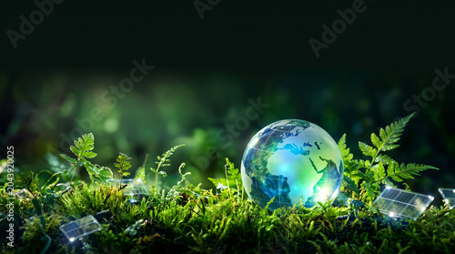 Sustainable Development Concept with Glass Earth Globe and Solar Energy