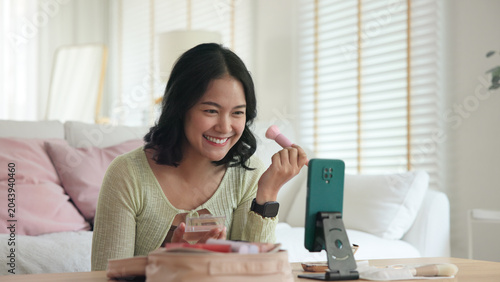 Quadro su tela Asia people young gen z female happy smile enjoy phone apply selfie screen makeup blush virtual AI tech scan face app AR mixed augmented reality future beauty smart iot skin care help guide advice