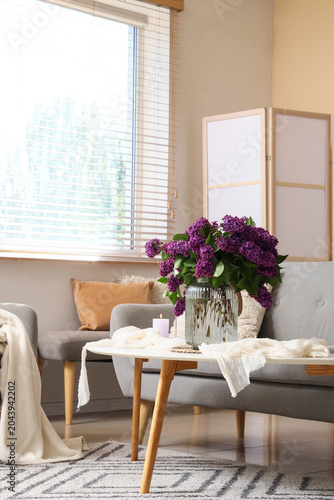 Vase with lilac flowers and...