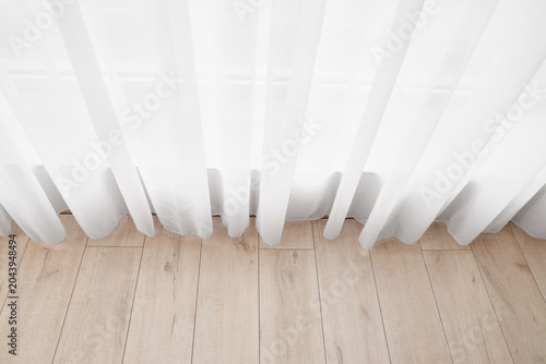 White sheer curtain over li...