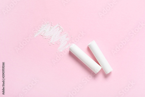 White chalks on pink backgr...