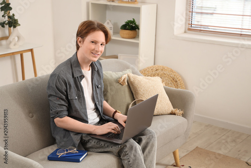 Teenage boy with laptop wor...