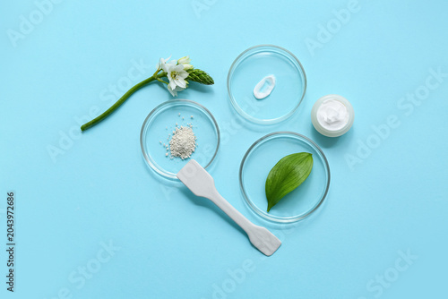 Jar of cream, Petri dishes with samples and ingredients for preparing natural...