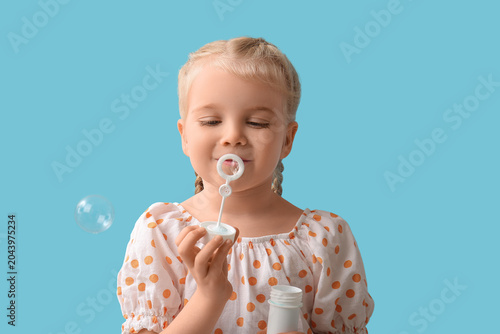 Cute little girl blowing so...