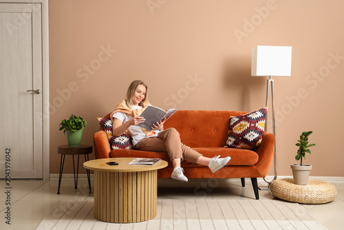 Young woman reading magazin...
