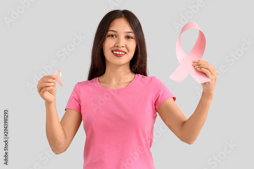 Young Asian woman with pink...
