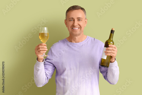 Mature man with glass and b...