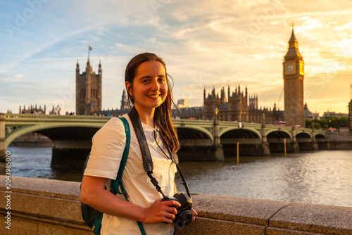 Photography Female tourist photographer with camera near Palace of Westminster, Big Ben cloc
