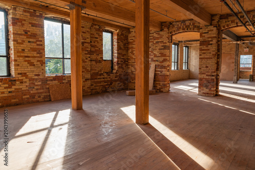 Industrial Loft Interior With Sunlight And Brick Walls
