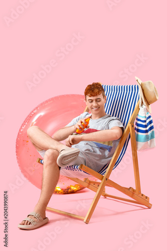 Young man applying sunscree...