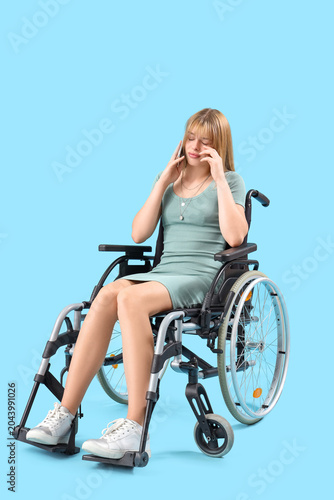 Upset young woman in wheelc...