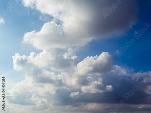 Blue sky with fluffy white clouds on a beautiful sunny day