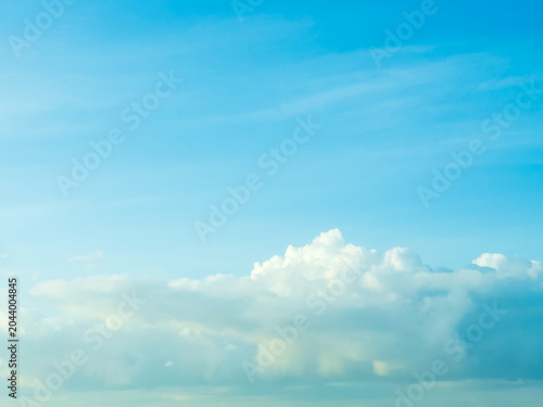 Blue sky with fluffy white clouds on a beautiful sunny day