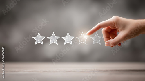 Hand touching a row of five stars on a wooden surface representing high quality rating