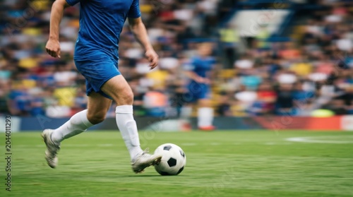 Professional male soccer player dribbling ball on green grass field during competitive match