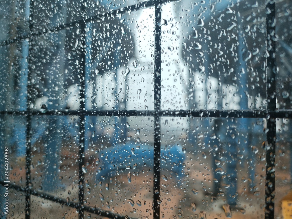 Obraz premium Abstract Rain Texture on Glass with Blue Industrial Background