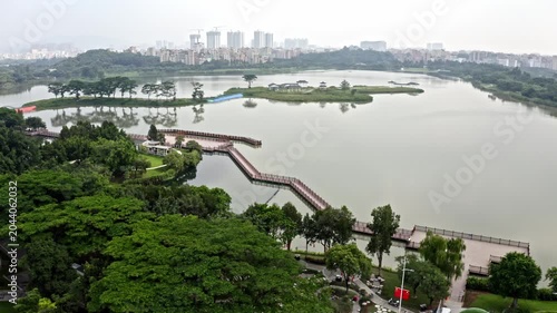 Aerial View of Urban Lake Park with Boardwalk and City Skyline