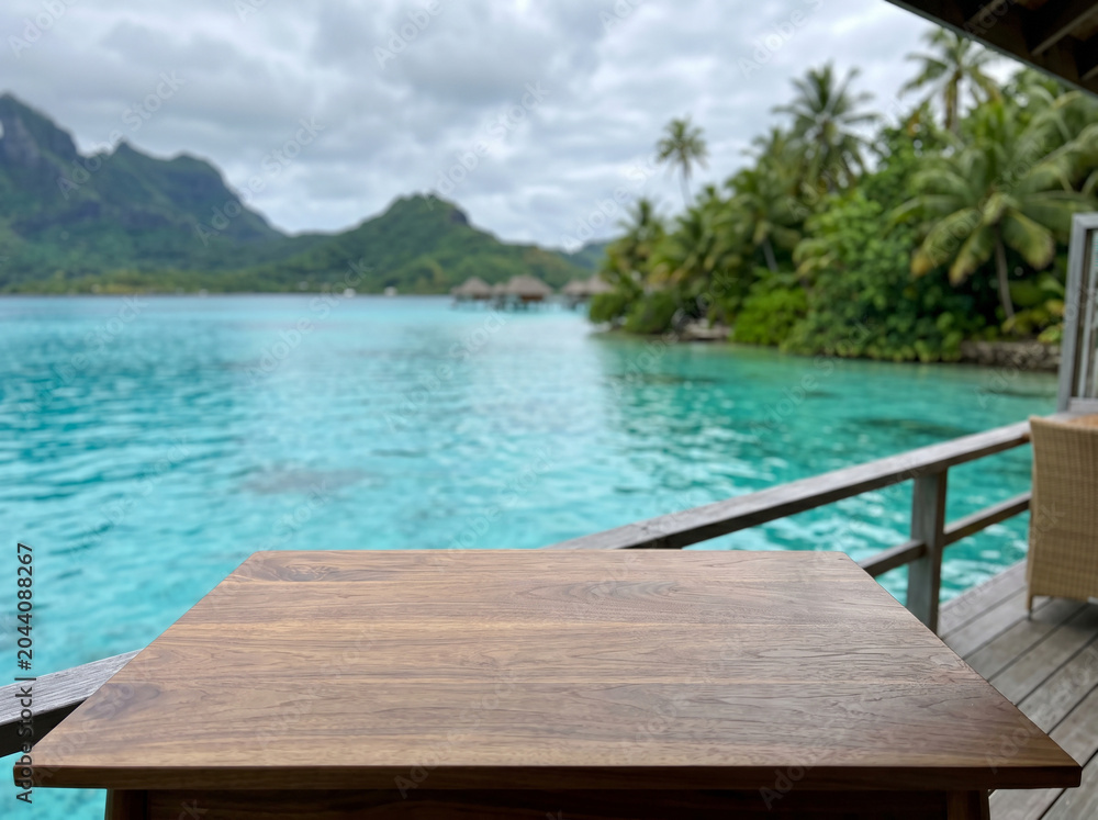 Fototapeta premium Wooden table overlooking turquoise lagoon and overwater bungalows in Bora Bora