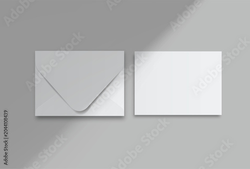 Envelope and blank invitation card mockup on background with soft natural window shadows. Template for wedding stationery printing, greeting cards, and corporate identity design.