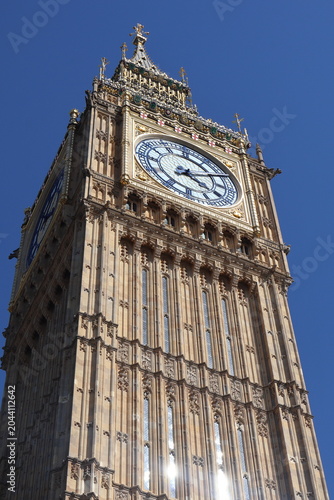 Big Ben and Elizabeth Tower at the Palace of Westminster on a sunny day, London, UK. Famous British landmark with blue sky