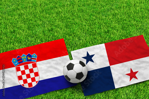 Foto Croatian and Panamanian flags with soccer ball on green grass